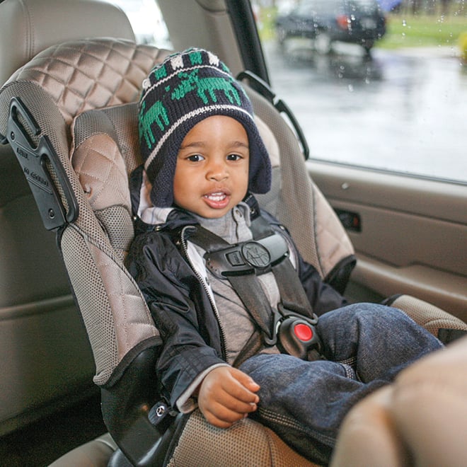 Toddler strapped into car seat 