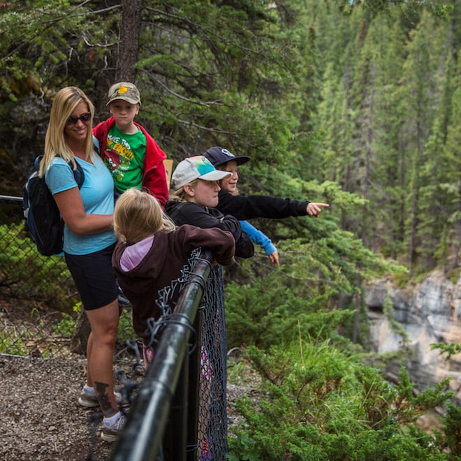 Kids looking over the fence railing at Maligne Canyon. Photo: Parks Canada, Olivia Robinson