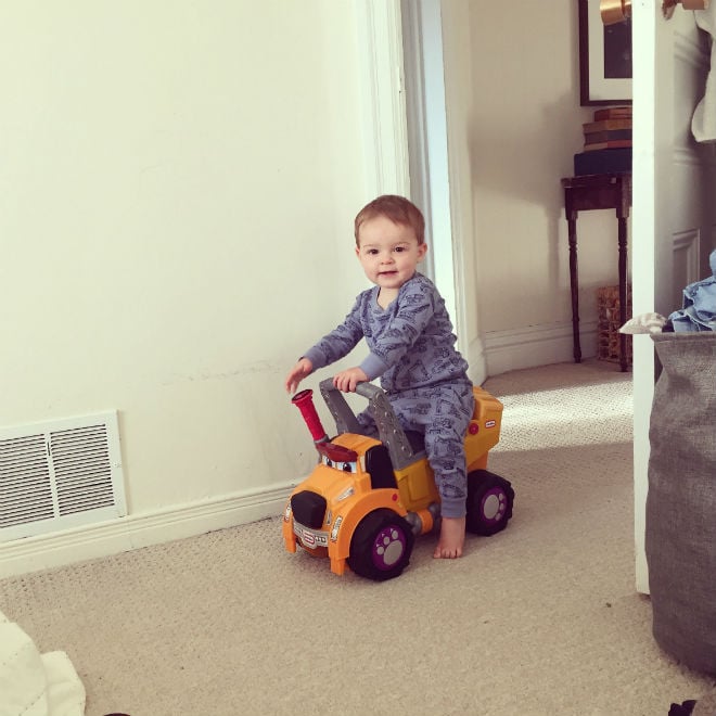 toddler on toy truck