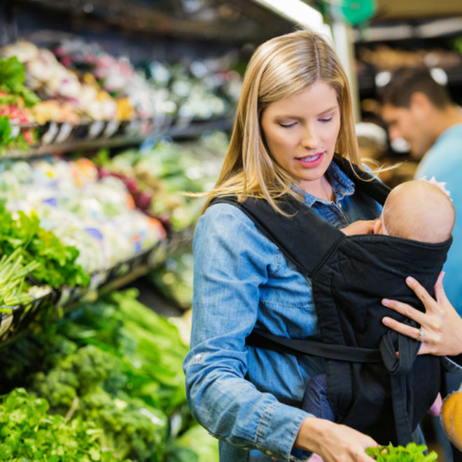 Mom holding baby at grocery store