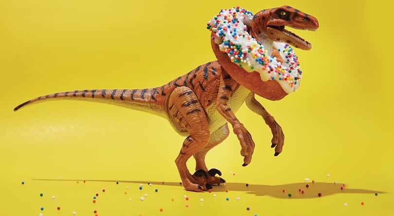 dinosaur wearing a donut