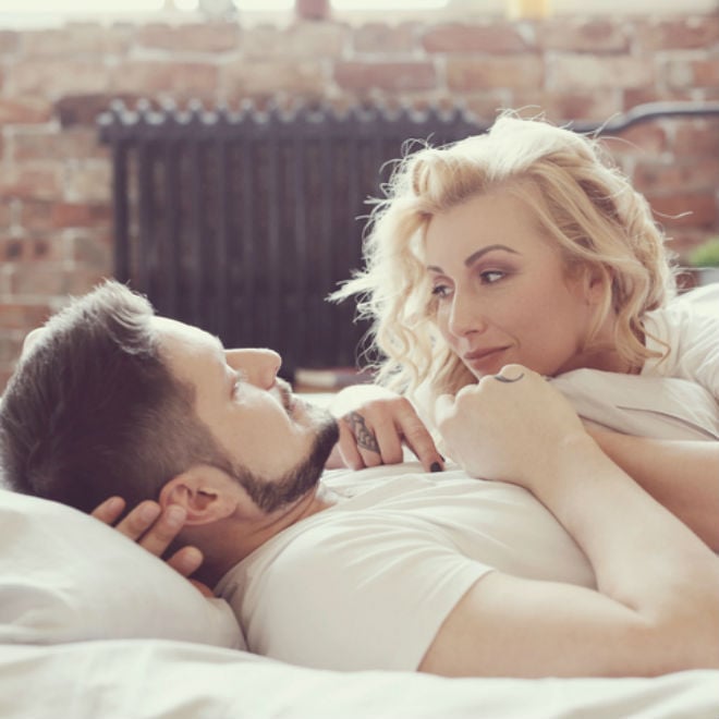 Couple in bed gazing at each other