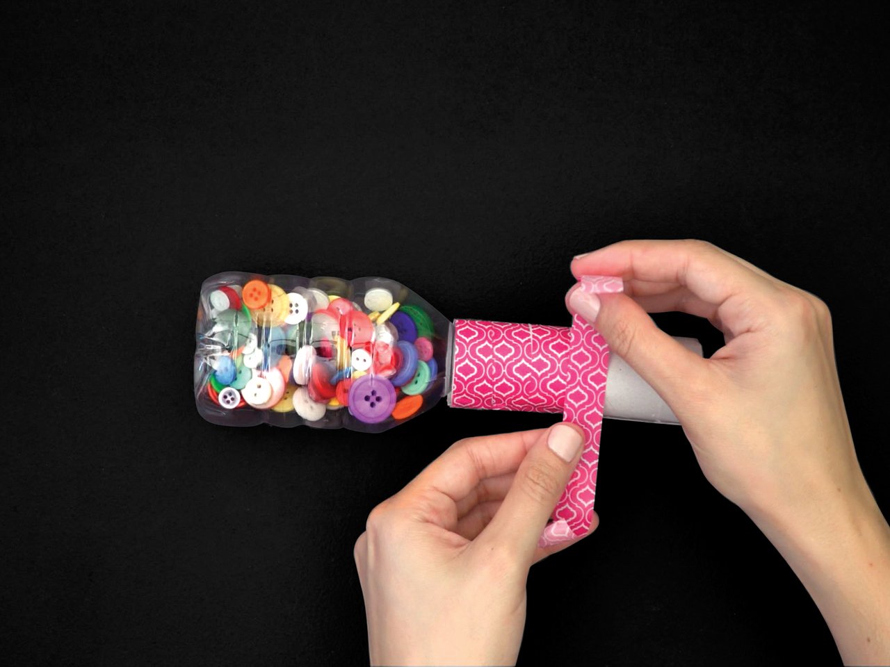 wrapping washi tape around a toilet paper roll