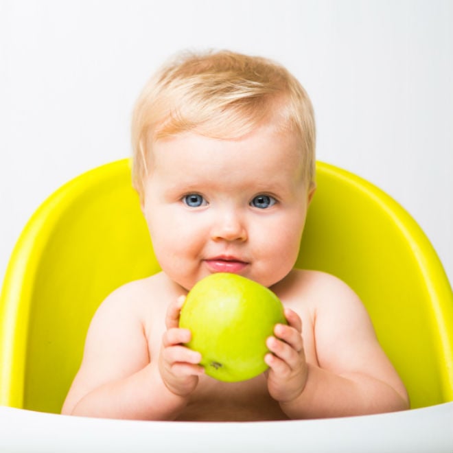 baby holding apple