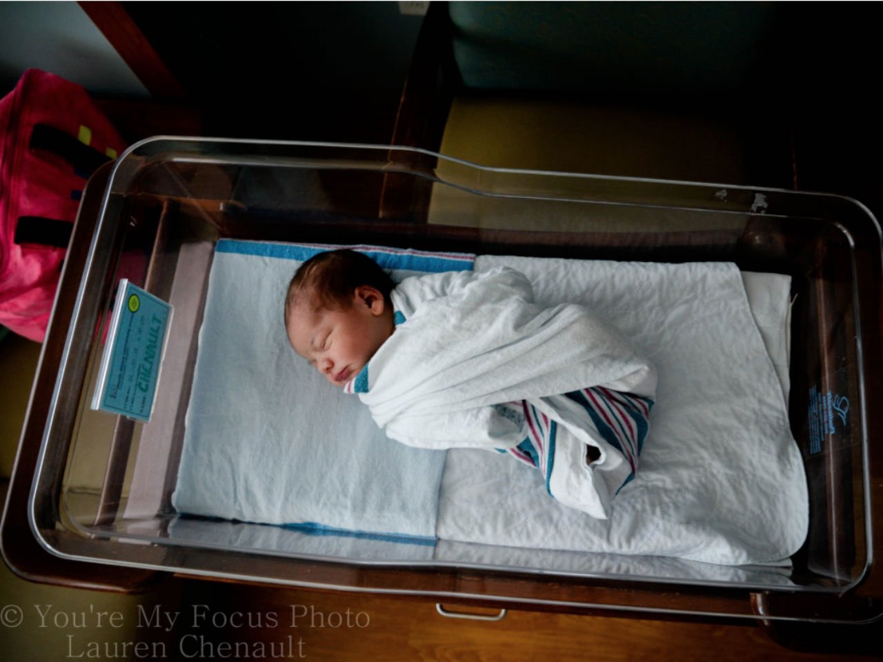above shot of newborn baby swaddled in the hospital