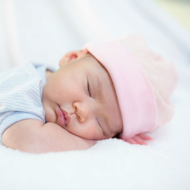 baby in pink hat sleeping