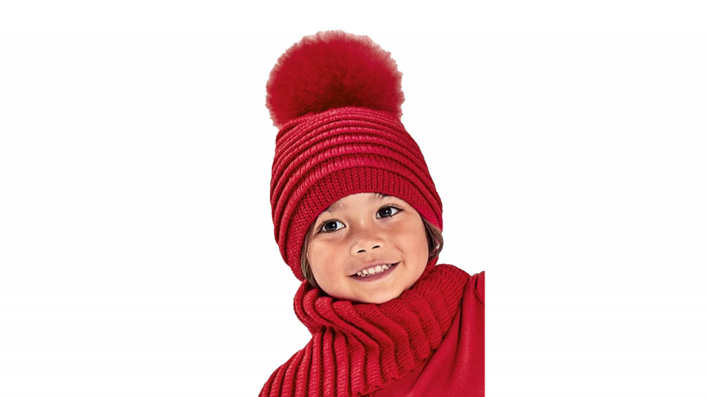 Kid wearing red pom pom hat