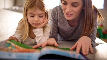 step parent and daughter reading a book