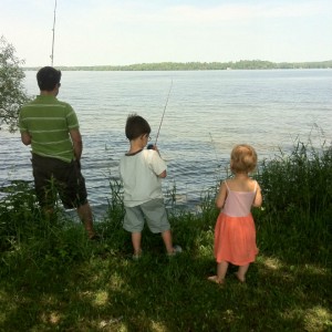 kids fishing with their father
