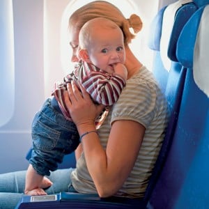 mom on airplane with baby