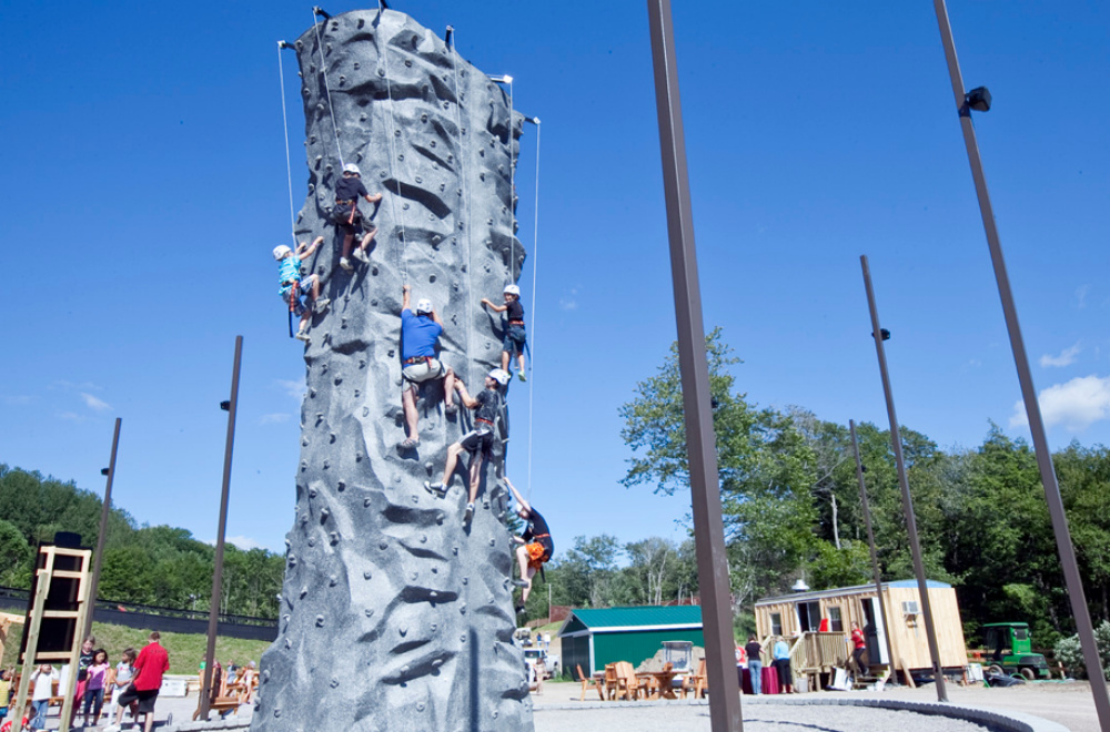 people climbing large outdoor wall