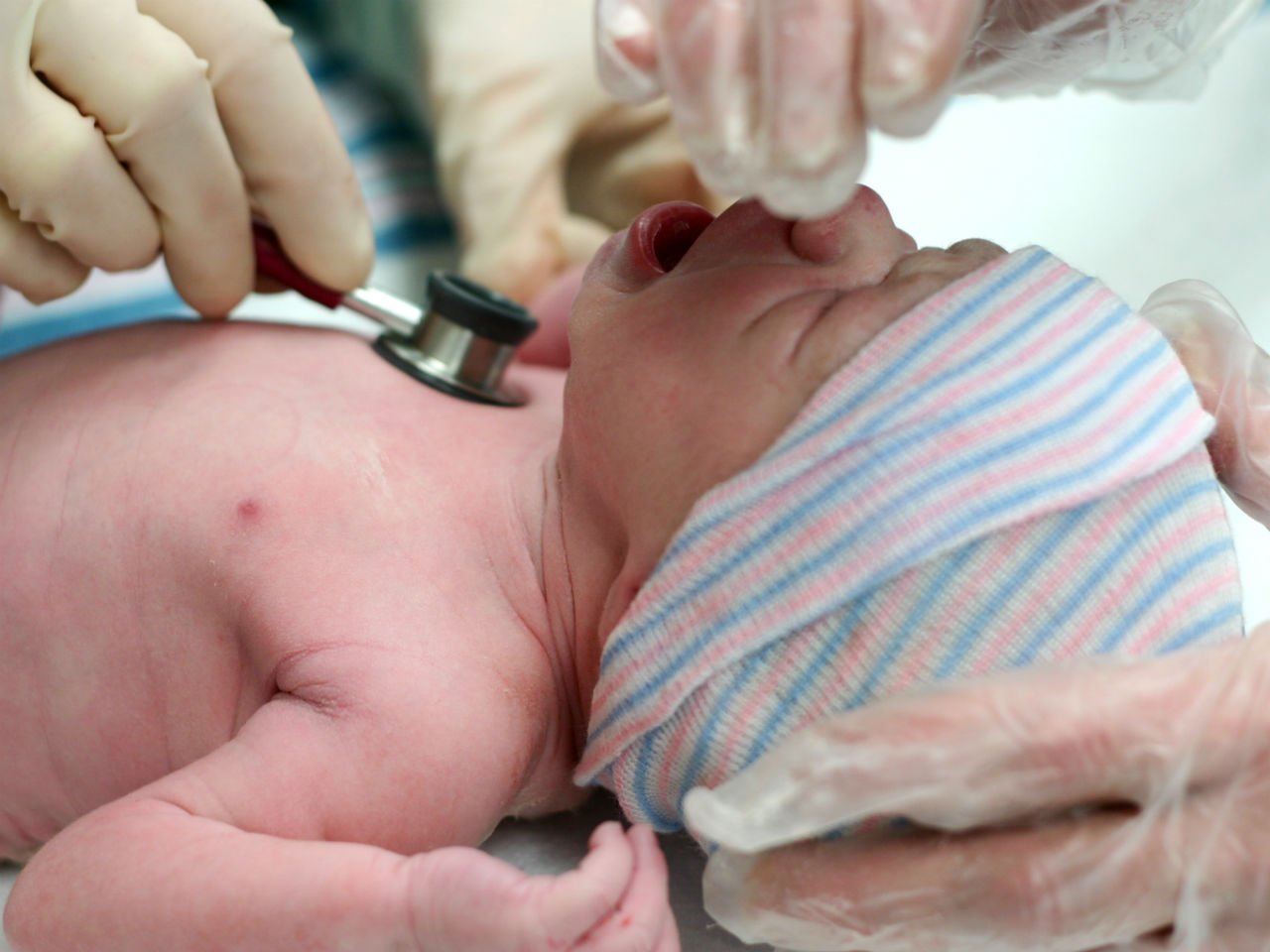 Newborn getting tested by doctor