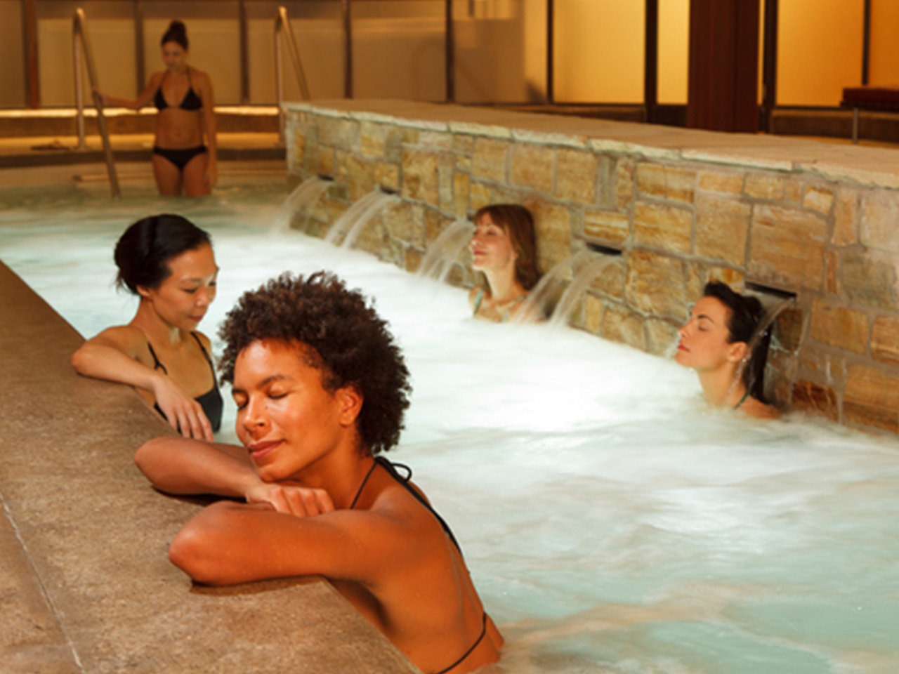 Photo of ladies relaxing in the pools at Body Blitz Spa