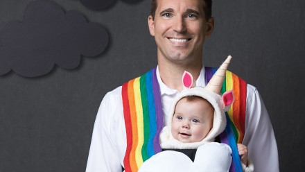 Dad and baby dressed up as a rainbow and unicorn