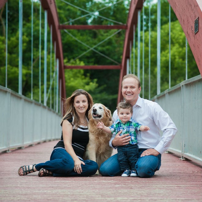 family having portrait taken on a bridge