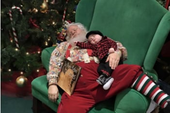 The baby was nestled all snug in Santa's lap...