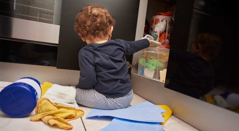 baby grabbing hazardous substances from the cupboard, prevent poisonings