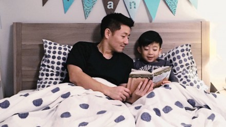 A bad reading to his son in bed