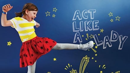 Young girl kicking through an illustation that says act like a lady