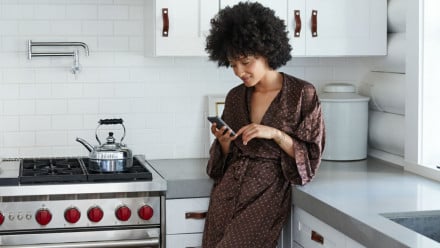 Woman in a robe looking at her phone