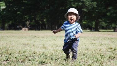 Little boy crying in the park during summer