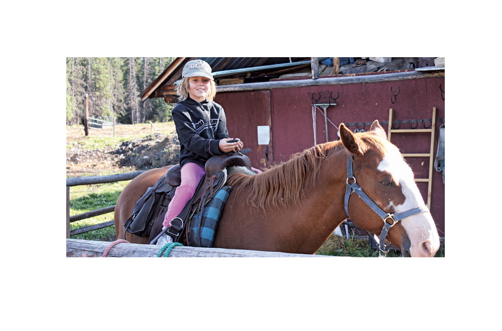 girl riding a horse on a ranch