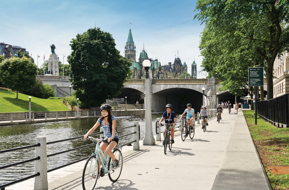 people biking along a river in Ottawa