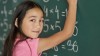 girl doing math on chalkboard