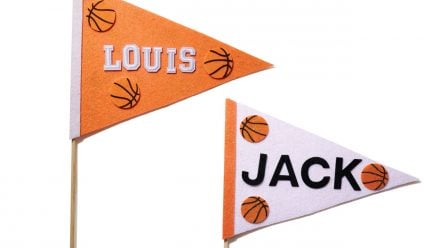 orange and white felt pennants with kids' names and little basketballs on them