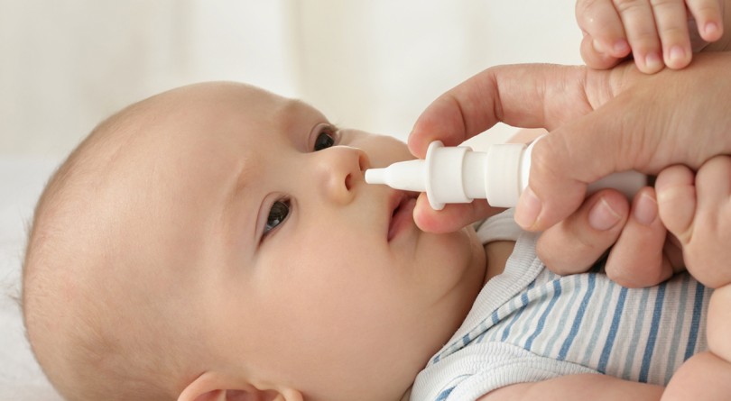 Using nasal spray on a baby