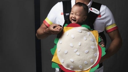 A baby dressed up as a hamburger