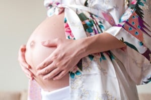 A pregnant woman in a robe