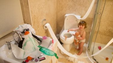 toddler making a mess in the bathroom