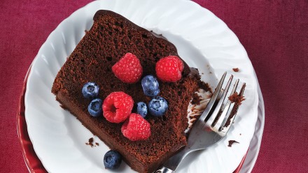 plate with chocolate cake topped with berries