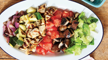 plate with grilled chicken, zucchini, red onion, mushrooms and lettuce and tomato
