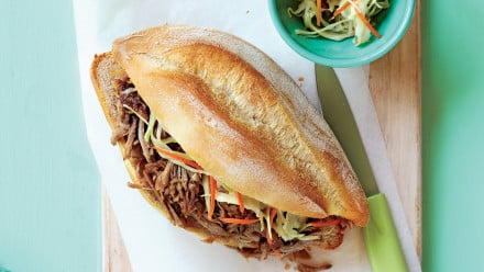bun with pulled pork and a side of slaw