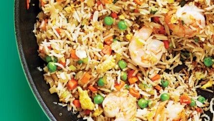cast iron pan with rice, shrimp, eggs and mixed veggies