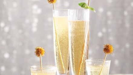 Champagne in four glasses with a glittering background