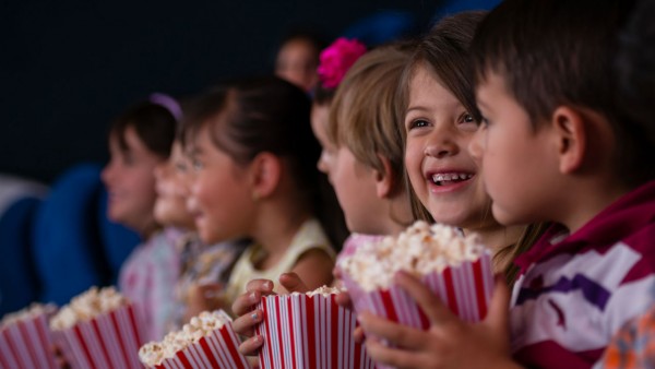 Kids with popcorn at the movie