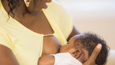 Mother breastfeeds her baby