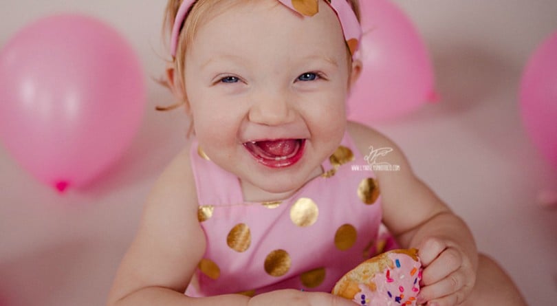Baby in pink doing a donut smash