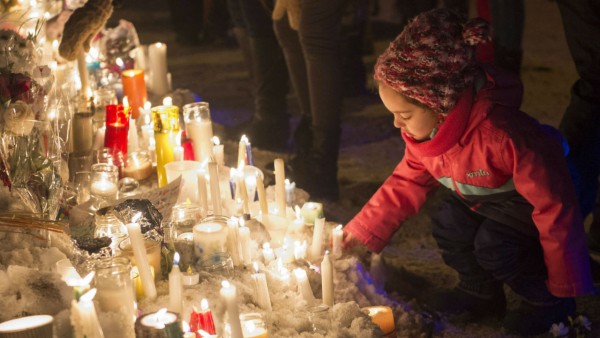 child at a candlelit vigil