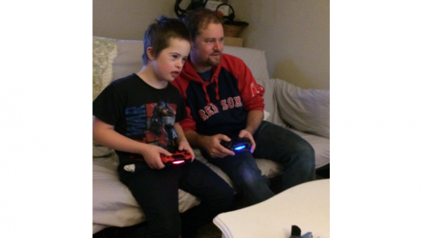 father and son play video games