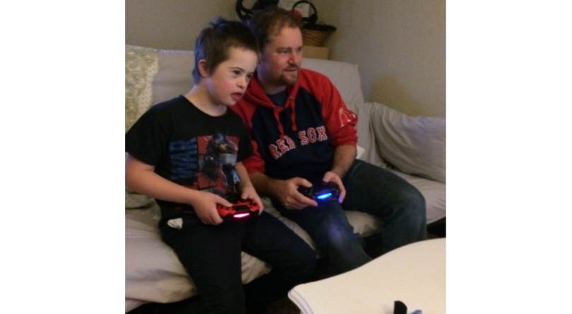 father and son play video games
