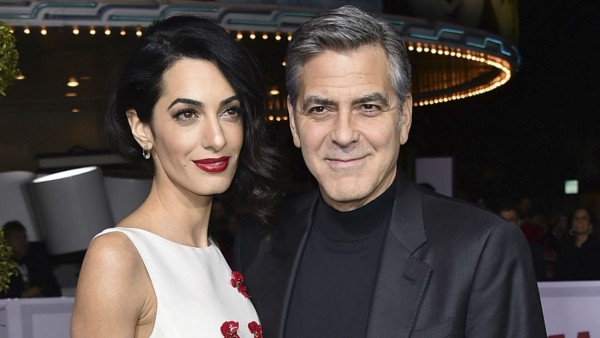George and Amal Clooney smiling at a movie premiere