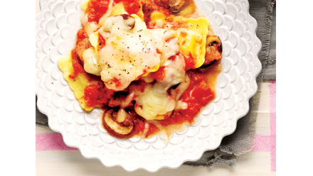 bowl of ravioli with cheese and tomatoes
