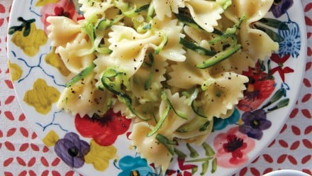 plate of bowtie pasta with light dressing, cracked black pepper and grated zucchini