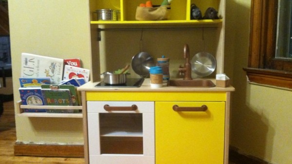 Yellow play kitchen in the author's living room