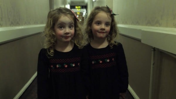Dad's girls posed as The Shining twins in a hotel hallway