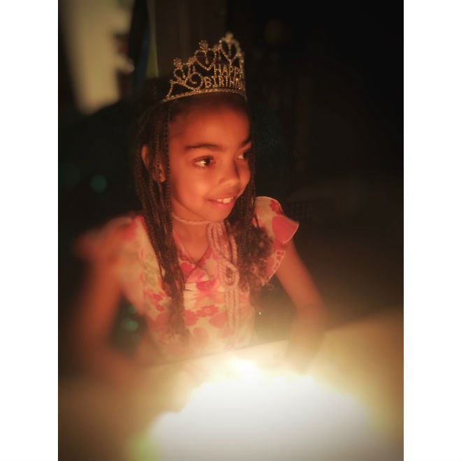 Nancy's daughter who has a chronic illness wearing a crown celebrating her birthday